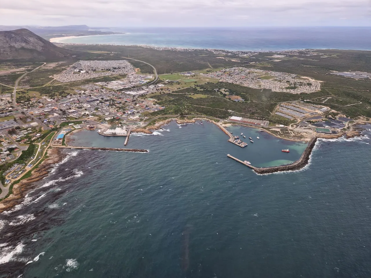 Aerial view of a harbour, beaches and ocean along the Cape Whale Coast