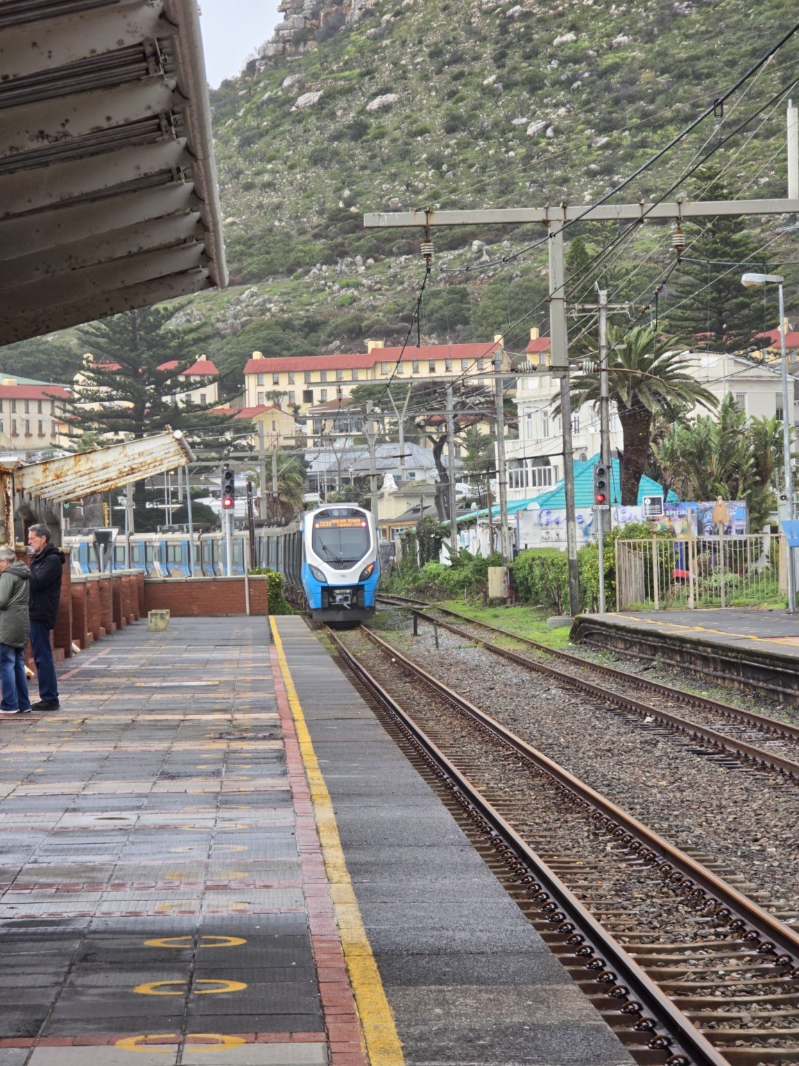 Kalk Bay railway station Metrorail Southern Line train approaching Kalk Bay railway station beneath the mountain, Cape Town