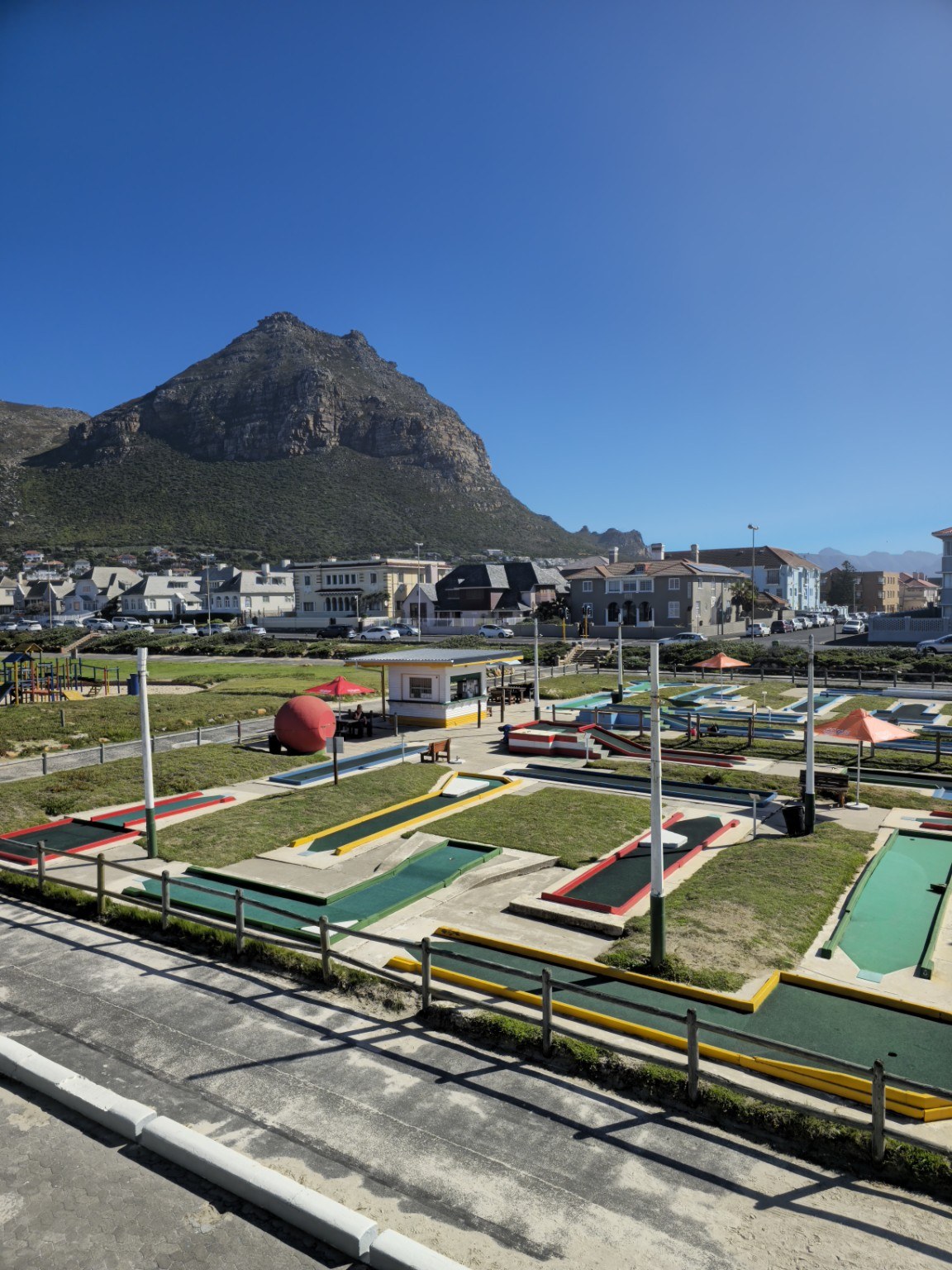 Muizenberg Putt-Putt miniature golf course with colourful lanes and the dramatic Muizenberg Mountain backdrop, Cape Town