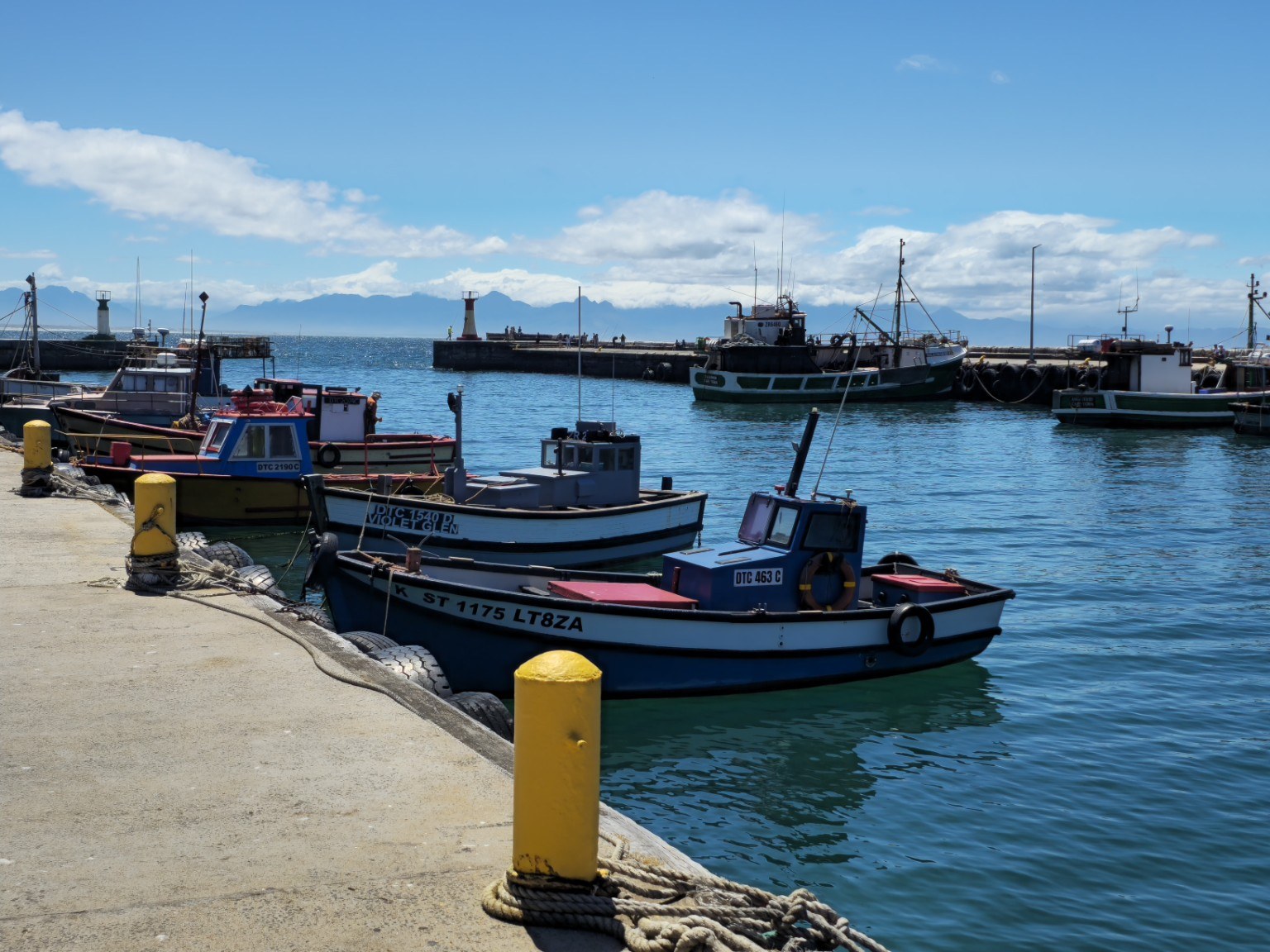 Kalk Bay fishing boats Colourful wooden fishing boats and breakwater inside Kalk Bay Harbour, Cape Town