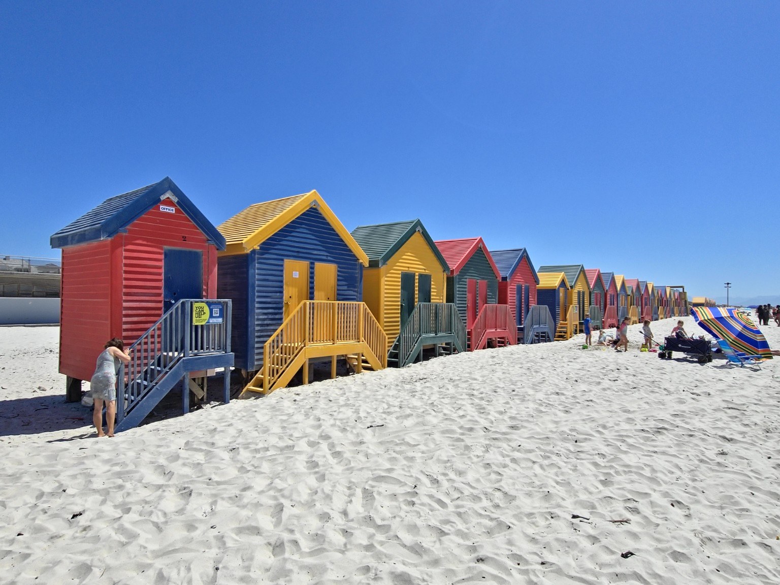Close-up of the rainbow-coloured Victorian bathing huts on Muizenberg Beach at Surfers Corner where the surf schools operate, Cape Town
