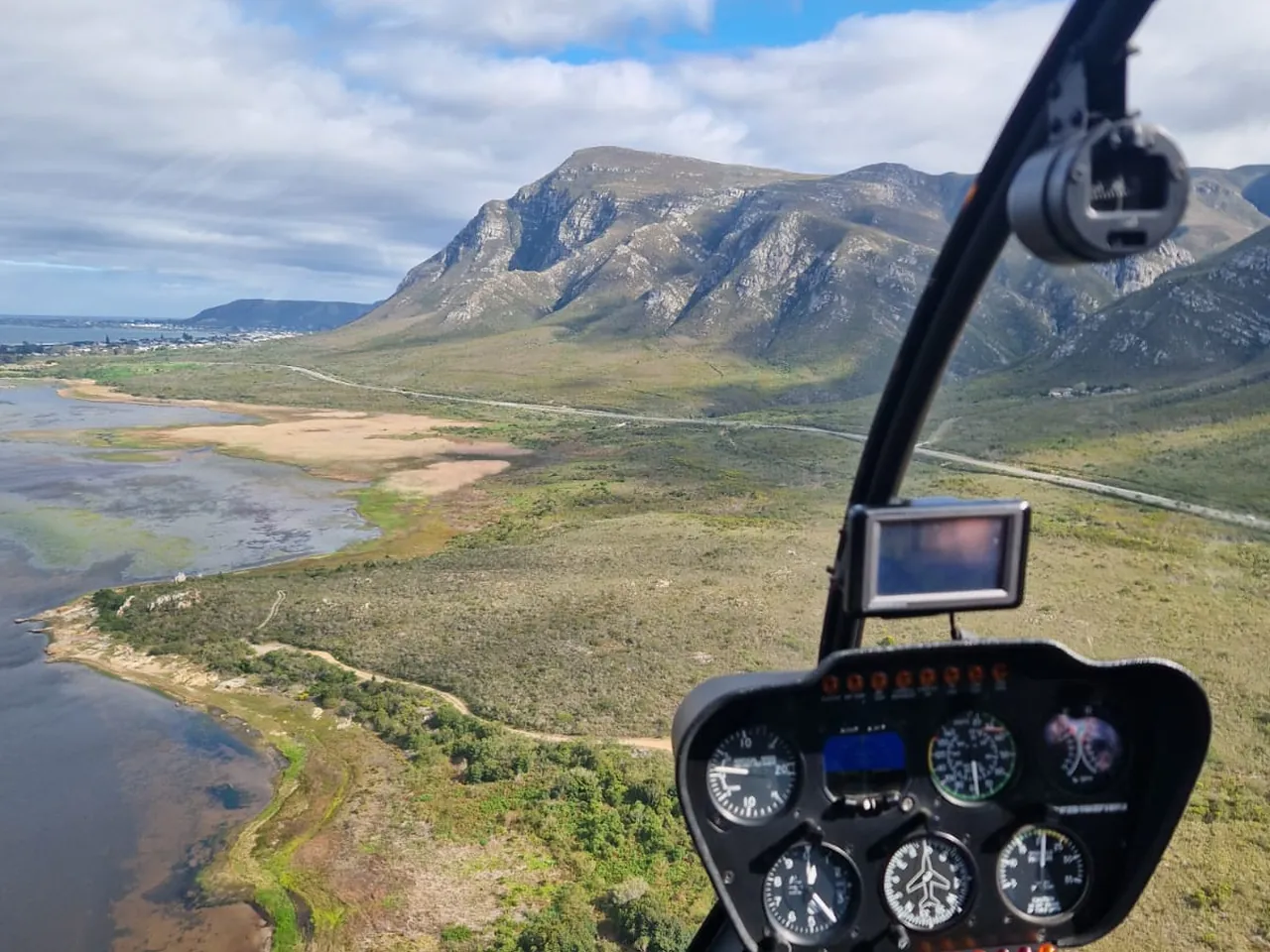 Klein River lagoon and the Overberg mountains seen from a helicopter cockpit near Hermanus